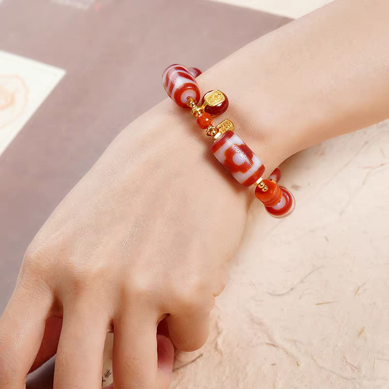  Authentic barrel-shaped red meat agate Dzi bead bracelet, showcasing Buddhist sacrificial items art and Tibetan Buddhist sacrificial implements culture.