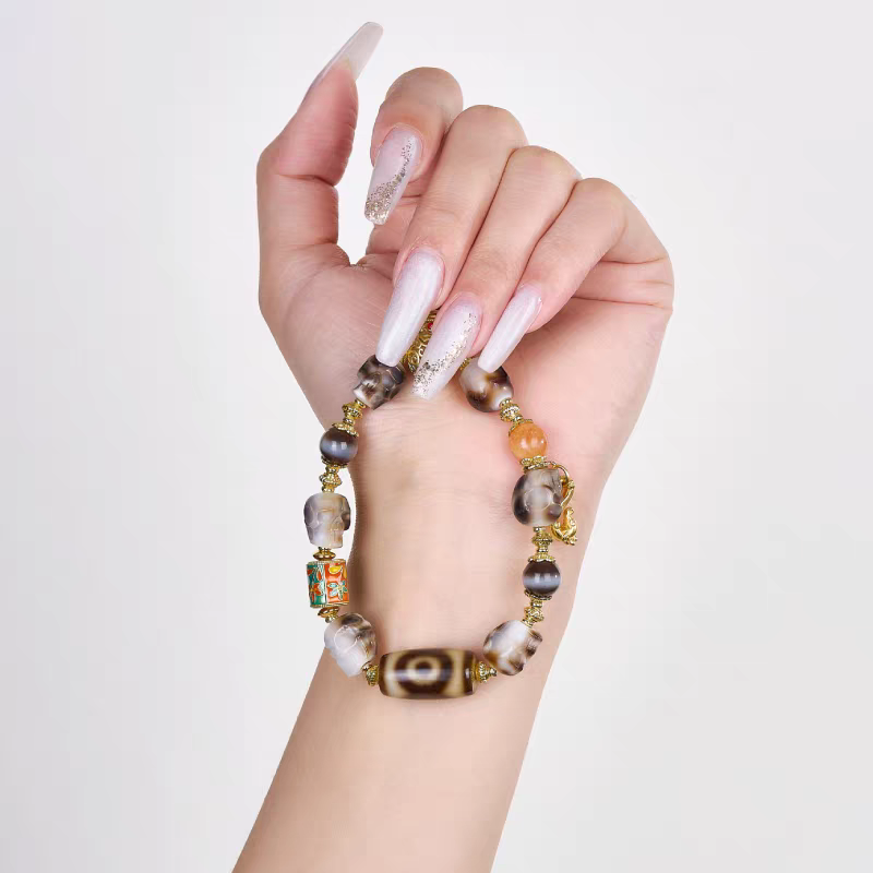 Authentic Panda black and white Citipati skull Dzi bead bracelet, showcasing Buddhist sacrificial items art and Tibetan Buddhist sacrificial implements culture.