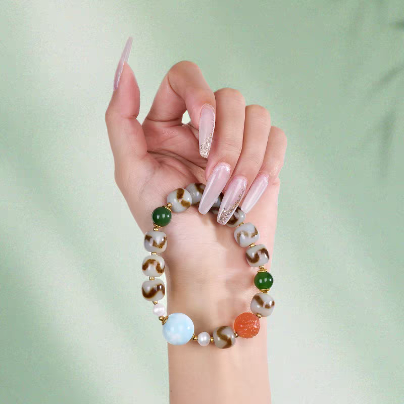  Authentic blue Larimar and Tiger Tooth Dzi bead bracelet, showcasing Buddhist sacrificial items art and Tibetan Buddhist sacrificial implements culture. Purely handmade.