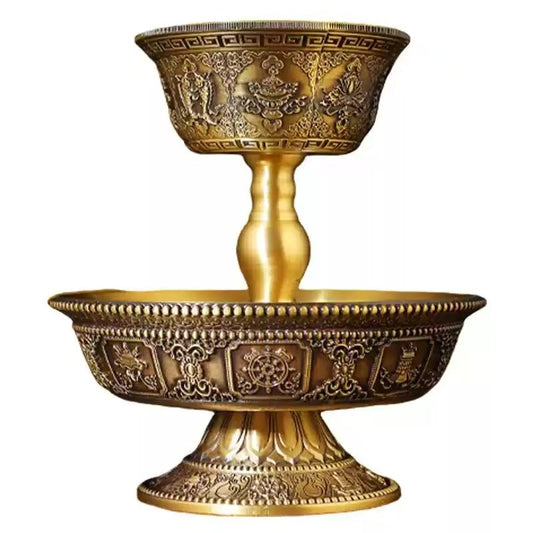 Tibetan Buddhist sacrificial implements culture: A majestic brass Dharmapala offering cup featuring the Eight Auspicious Symbols for invoking divine protection.
