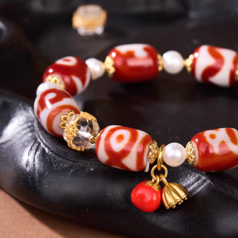 Exquisite tube-shaped natural red agate multi-pattern Dzi jewelry, a spiritual artifact rooted in Tibetan Buddhist sacrificial implements culture for success.