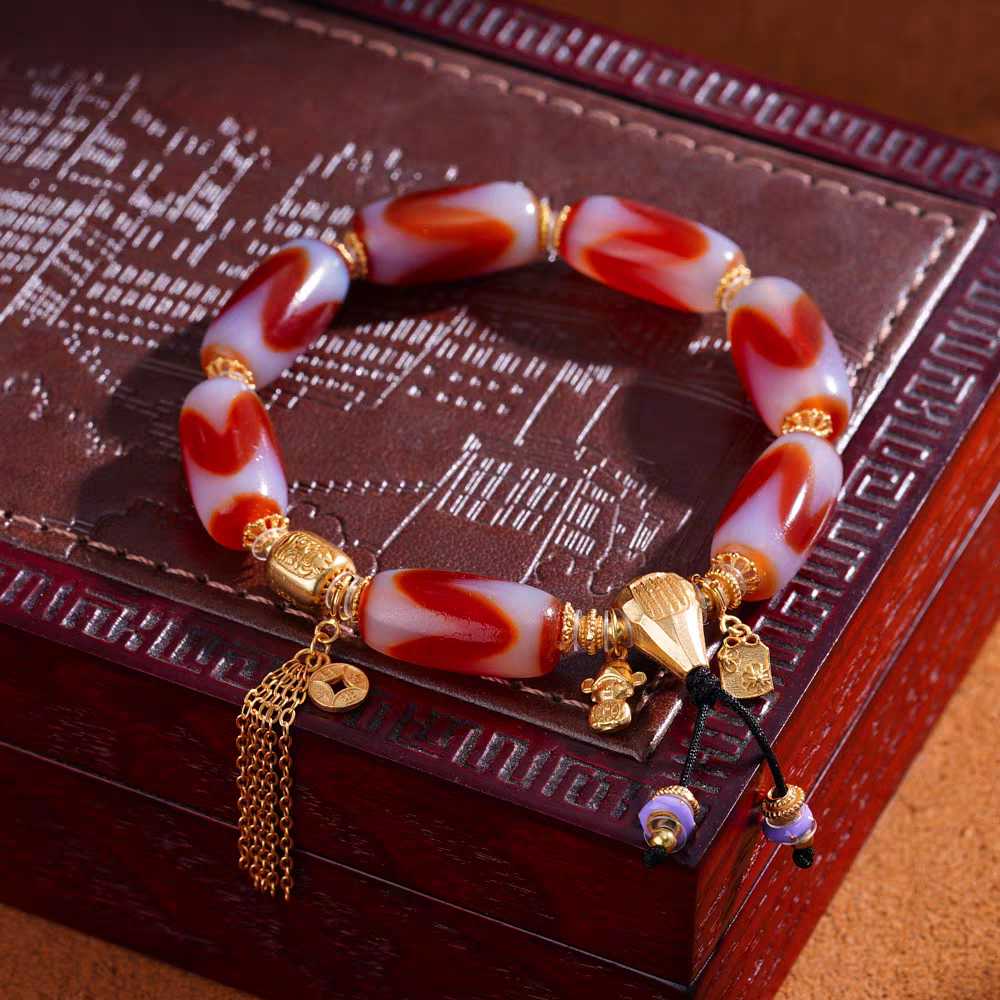 Tibetan Buddhist sacrificial implements culture red meat mandala three-eyed Dzi bracelet. Handcrafted from natural agate as a piece of Buddhist sacrificial items art.
