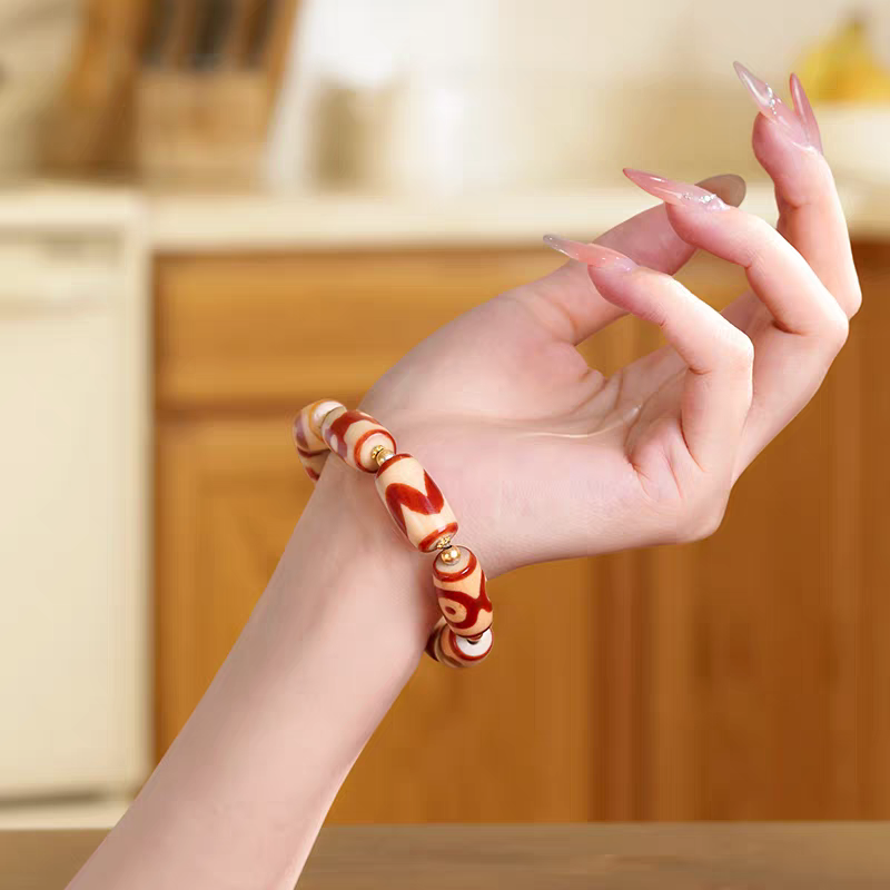 Authentic small barrel-shaped red meat agate Dzi bead bracelet, showcasing Buddhist sacrificial items art and Tibetan Buddhist sacrificial implements culture. Purely handmade.