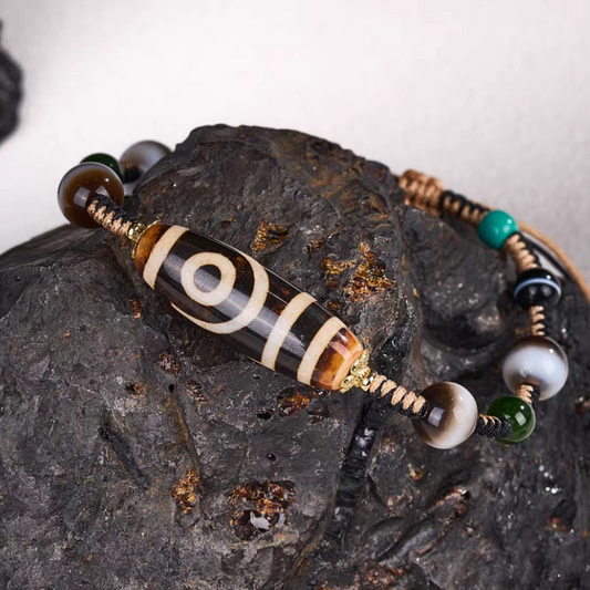 Tibetan Buddhist sacrificial implements culture ivory yellow two-eyed Dzi bead bracelet. Handcrafted from natural agate as a piece of Buddhist sacrificial items art for harmony.