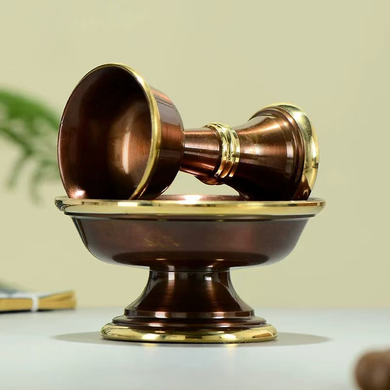 Tibetan Buddhist sacrificial implements culture: Close-up of an Ashtamangala brass chalice showcasing exquisite Buddhist sacrificial items art and hand-engraved details.
