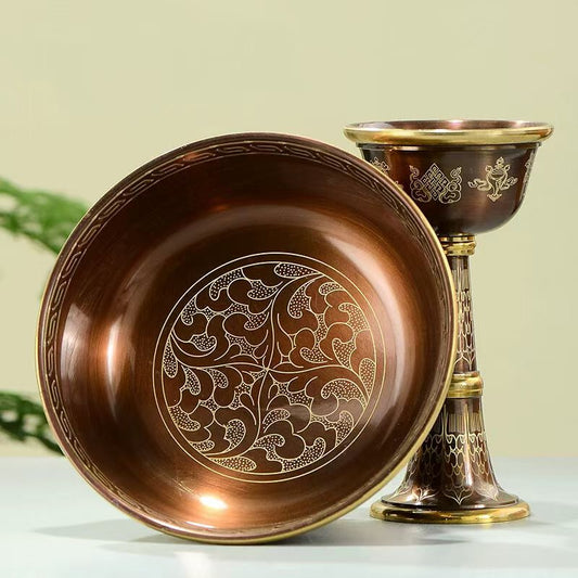 Tibetan Buddhist sacrificial implements culture: Detailed view of hand-engraved copper cups showcasing exquisite Buddhist sacrificial items art and traditional Himalayan craftsmanship.
