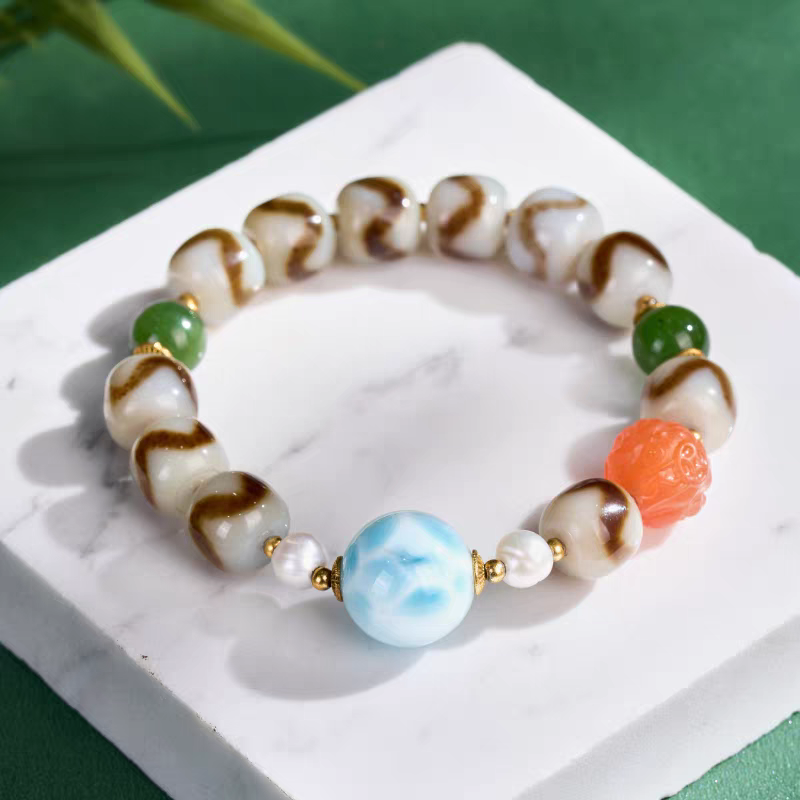 Handcrafted Larimar Dzi bracelet representing healing and protection in Buddhist sacrificial items art and ancient Tibetan traditions.