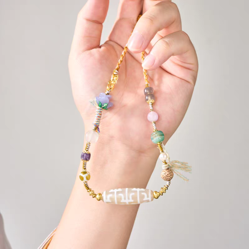 Handcrafted Buddhist sacrificial items art clavicle necklace with a sacred Guru Dzi, representing wisdom in Tibetan Buddhist sacrificial implements culture.