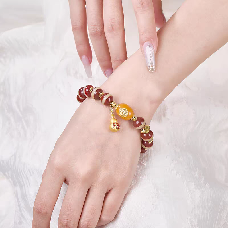 Handcrafted red Medicine Buddha bead bracelet representing healing and protection in Buddhist sacrificial items art and ancient traditions.
