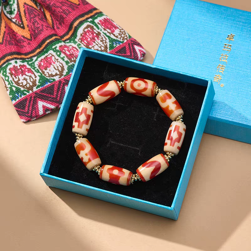  Exquisite mini tube-shaped natural red agate Dzi jewelry, a spiritual artifact rooted in Tibetan Buddhist sacrificial implements culture and craft.