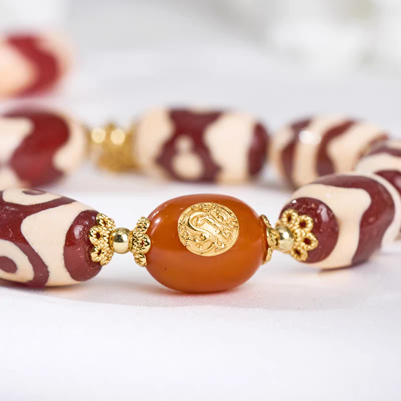  Tibetan Buddhist sacrificial implements culture red meat multi-treasure Dzi bead agate bracelet. Handcrafted from premium natural agate, reflecting traditional Buddhist sacrificial items art.