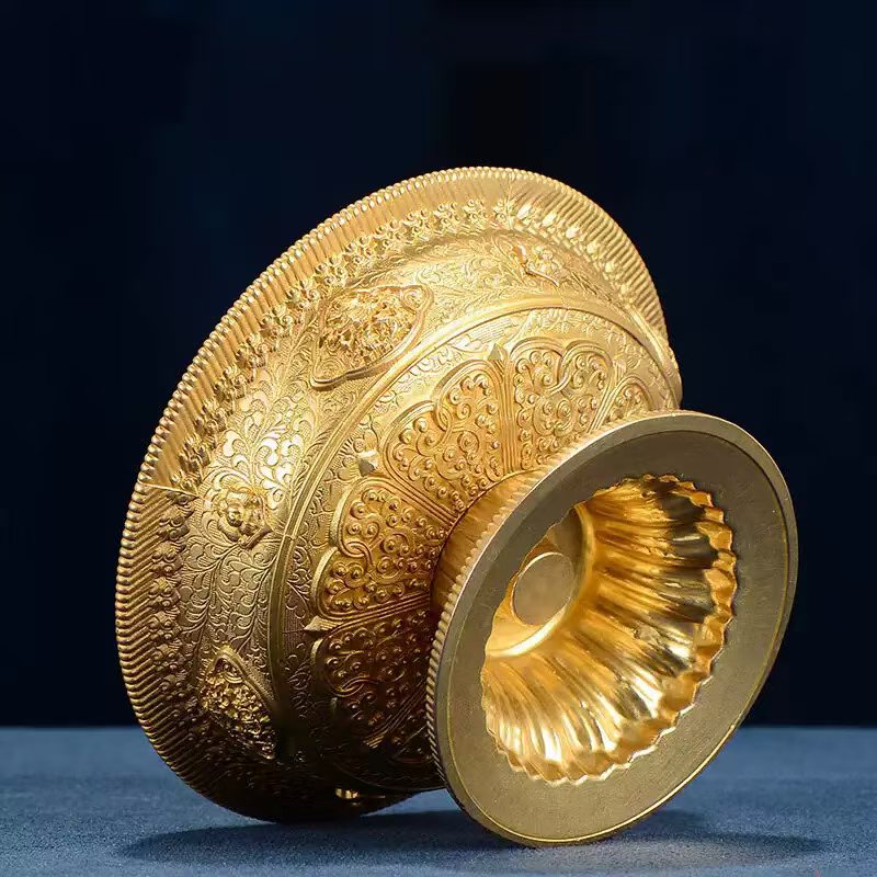 Buddhist sacrificial items art: An exquisite gilt bronze offering cup featuring sacred Buddhist symbols, reflecting the luxury of Tibetan religious heritage.
