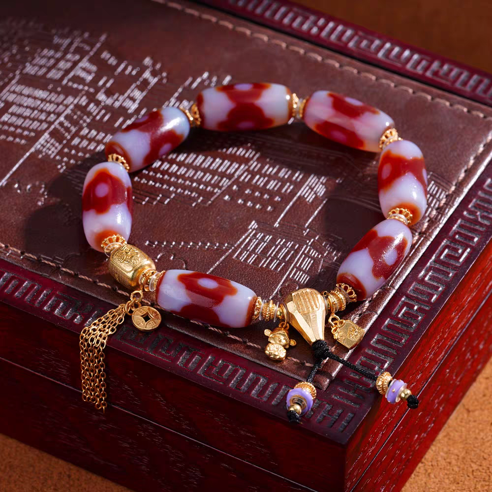 Handcrafted red agate Dzi bracelet with mandala motif, representing protection and prosperity in Buddhist sacrificial items art and ancient traditions.