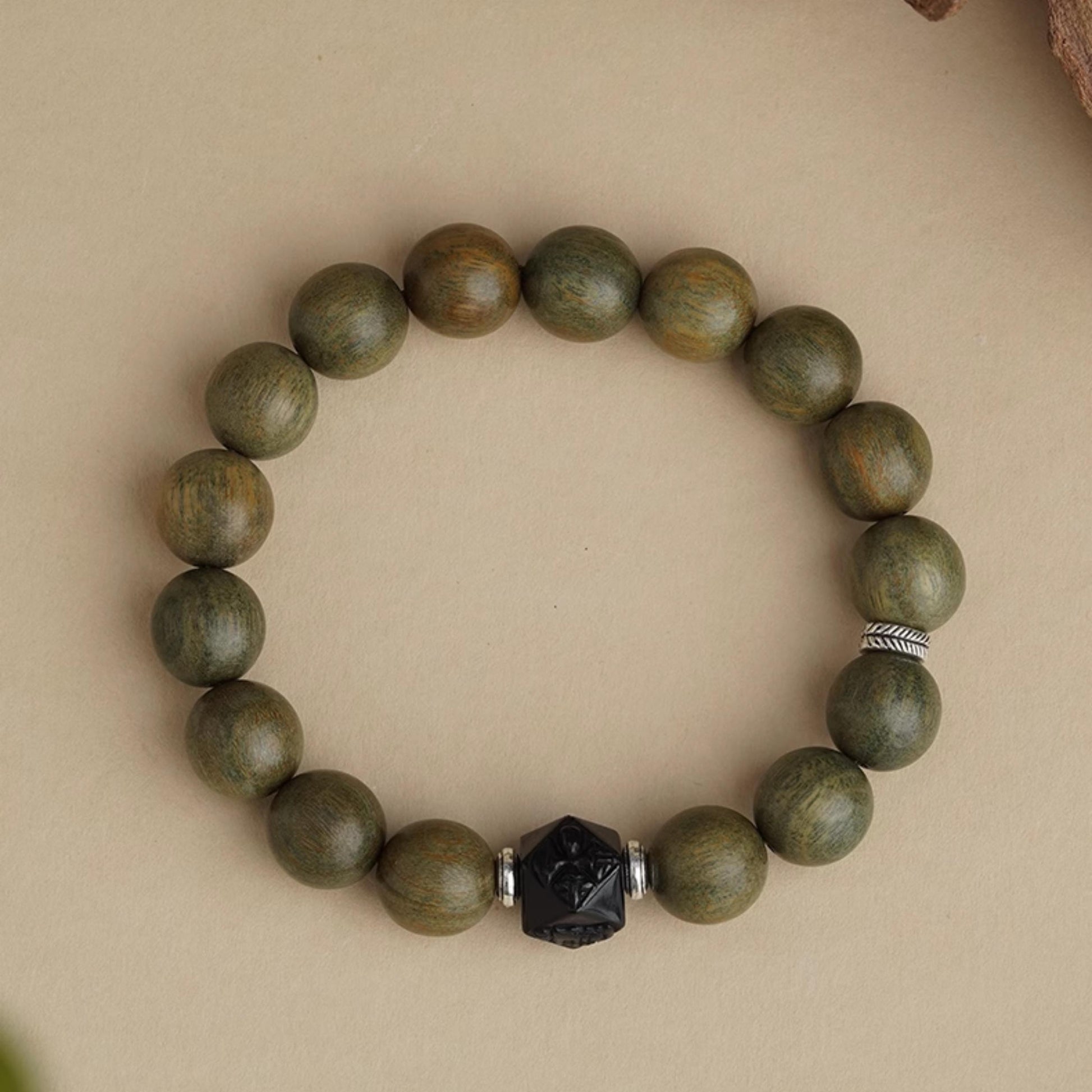 Serene Sandalwood Meditation Strand featuring pure handcrafted green sandalwood with obsidian and copper details. This Tibetan Buddhist jewelry art supports deep meditation practice.