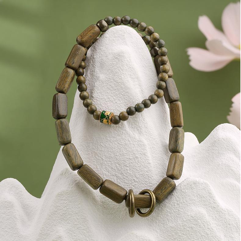 Handmade Tibetan Buddhist multi-strand bracelet featuring natural green sandalwood beads and sacred copper accents. This jewelry art piece embodies the gentle energy of a whispering wind, perfect for meditation and spiritual practice.