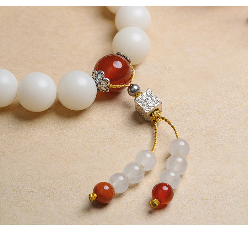 White Bodhi Root Mala handcrafted with agate and lapis lazuli beads. This Tibetan Buddhist jewelry culture piece embodies traditional craftsmanship for meditation practice.