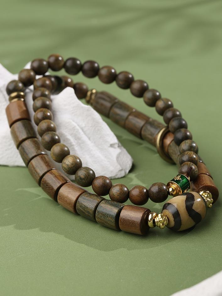 Agate tooth bead sandalwood mala handcrafted with copper details and sacred symbols. This Tibetan Buddhist jewelry art piece represents authentic Himalayan spiritual traditions.