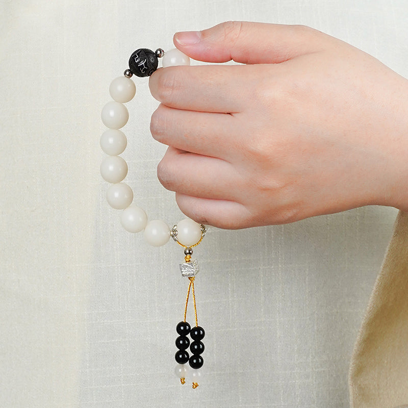 Bodhi Wisdom Strand showcasing hand-carved sacred wood beads. This Tibetan Buddhist jewelry culture supports wisdom development through traditional mala practice.