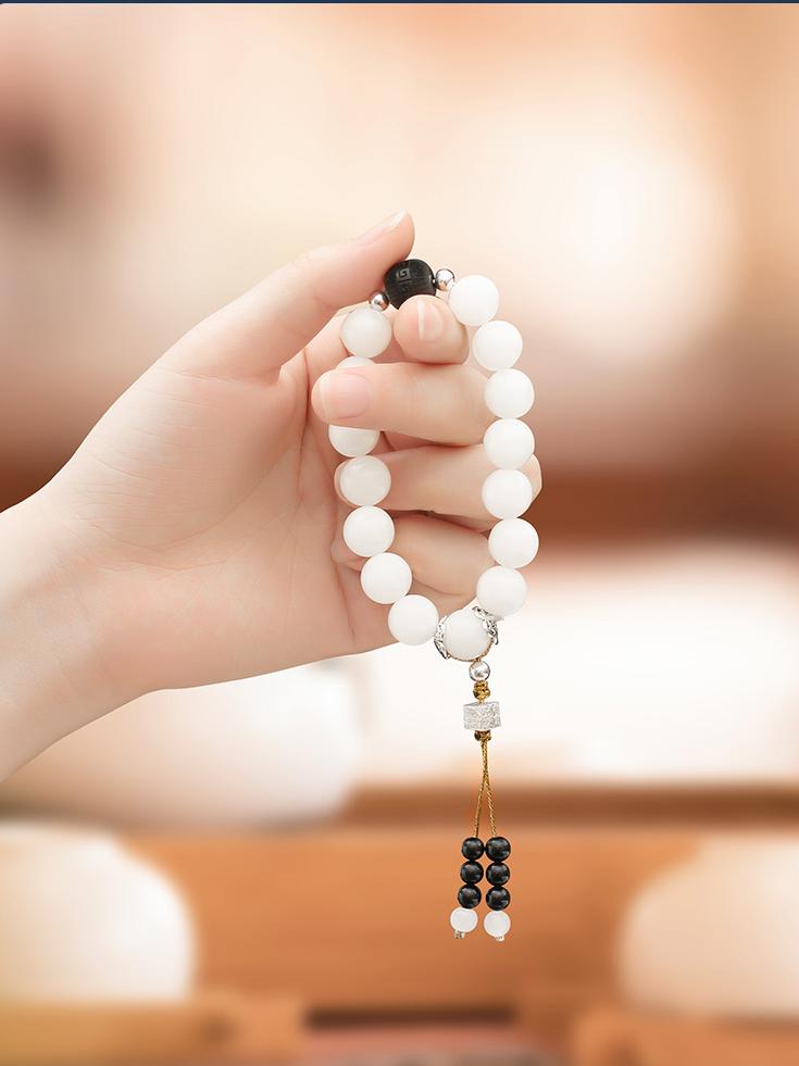 A string of prayer beads made of 12mm carved wooden beads, created using traditional techniques. This Tibetan Buddhist ornamental art supports spiritual awakening through sacred craftsm.