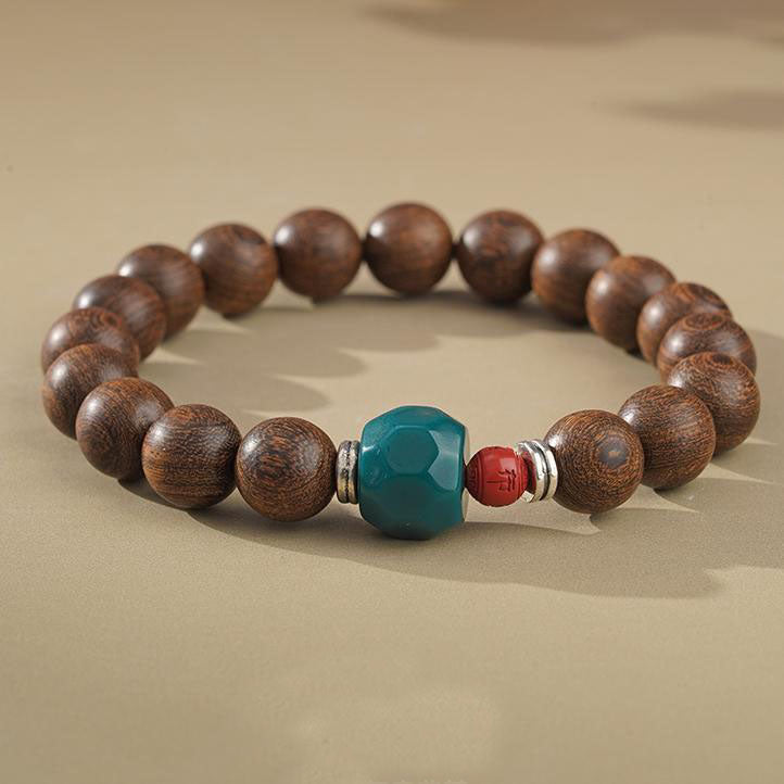Golden Satinwood Harmony Bracelet - A modern spiritual life mala inspired by Tibetan Buddhism jewelry culture. This genuine handcrafted piece combines rare satinwood, protective red cinnabar, and bright glass, made in accordance with traditional Tibetan proportions. Representing the harmony of nature and spirit in Tibetan Buddhism jewelry culture this hand is both a powerful meditation aid and a beautiful piece of natural wooden jewelry. Handcrafted by artisans.