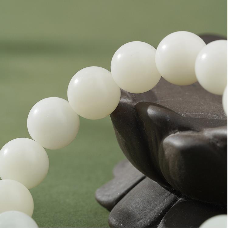 White Bodhi Spiritual Bracelet featuring lapis lazuli inlay and metalwork art. This Tibetan Buddhist jewelry art embodies sacred traditions.