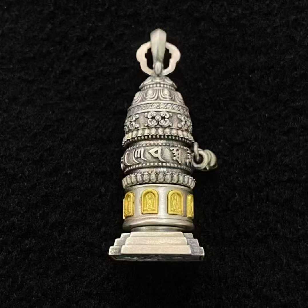 Experience Tibetan Buddhist jewelry culture through this fine-crafted 925 silver spinning prayer wheel pendant featuring authentic Tibetan script and traditional symbolism.