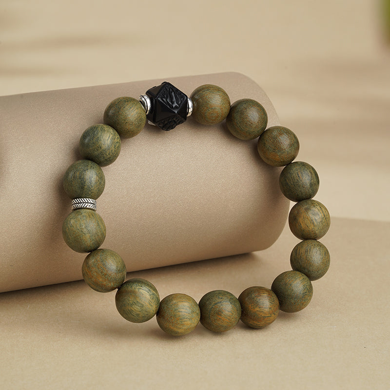 Green Sandalwood Protection Mala handcrafted with obsidian beads and copper ornaments. This Tibetan Buddhist jewelry culture piece provides spiritual shielding through traditional Himalayan craftsmanship.