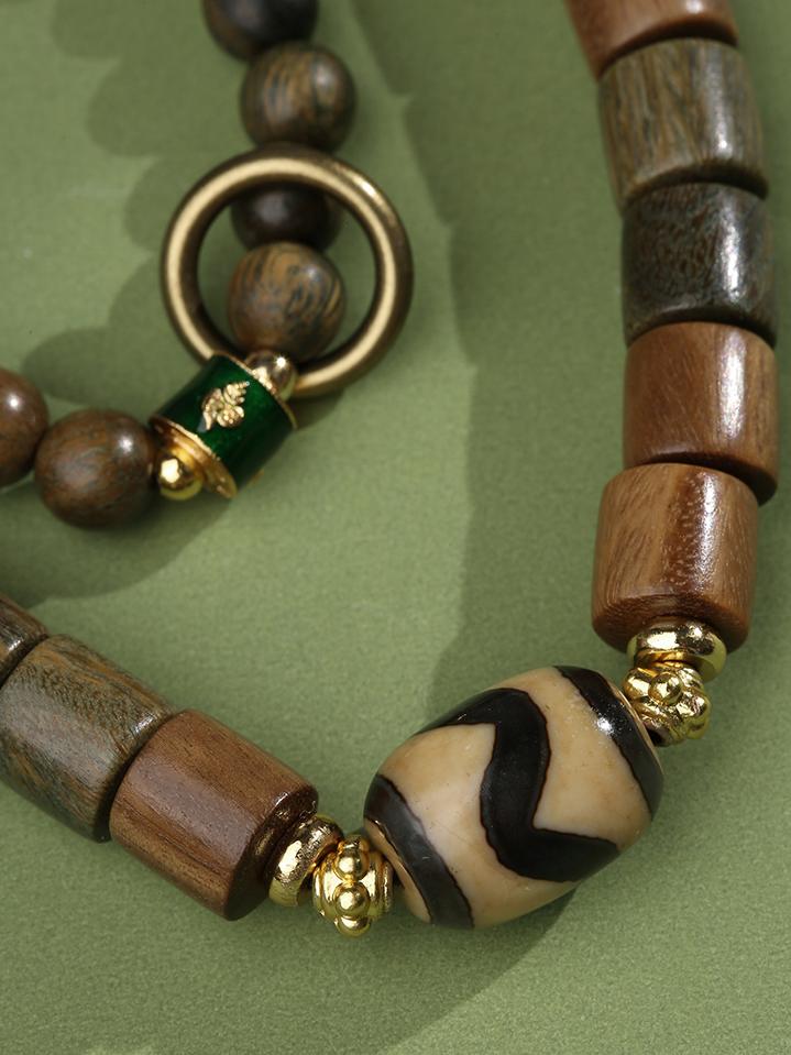 Sacred sandalwood agate strand with traditional Tibetan multi-strand design and alloy ornaments. Handmade using ancient Buddhist jewelry culture techniques.