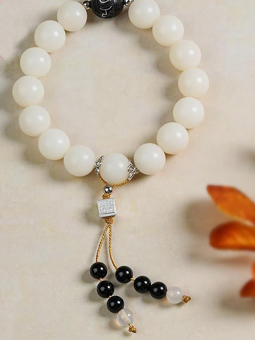 Serene Bodhi Meditation Strand with hand-carved wood beads and sacred art. This Tibetan Buddhist jewelry art enhances mindful practice through traditional methods.