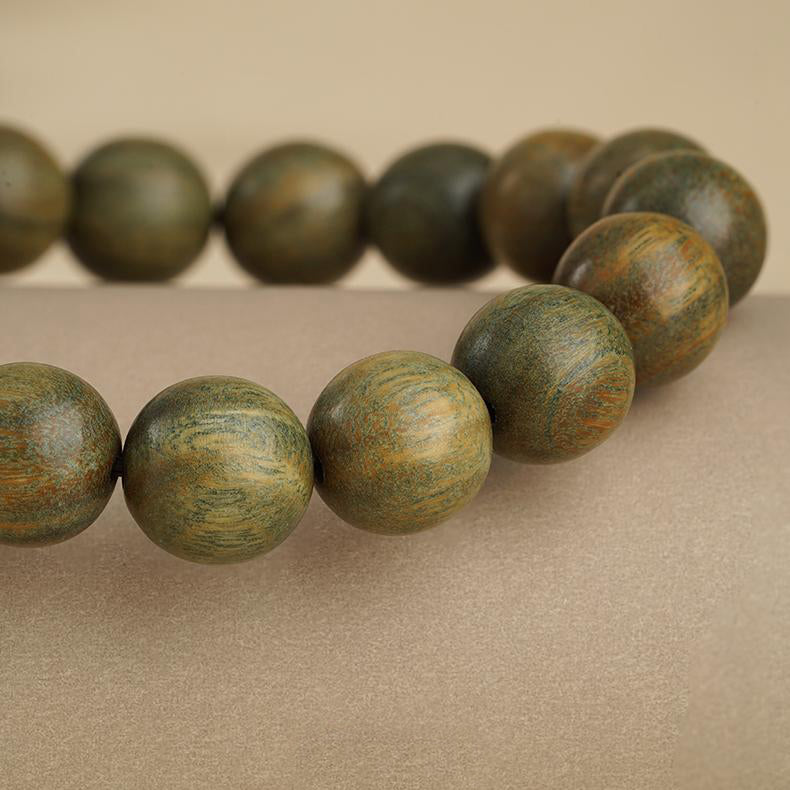 Sacred Sandalwood Prayer Beads with authentic Tibetan obsidian and copper elements. This jewelry culture creation represents protective spiritual traditions.