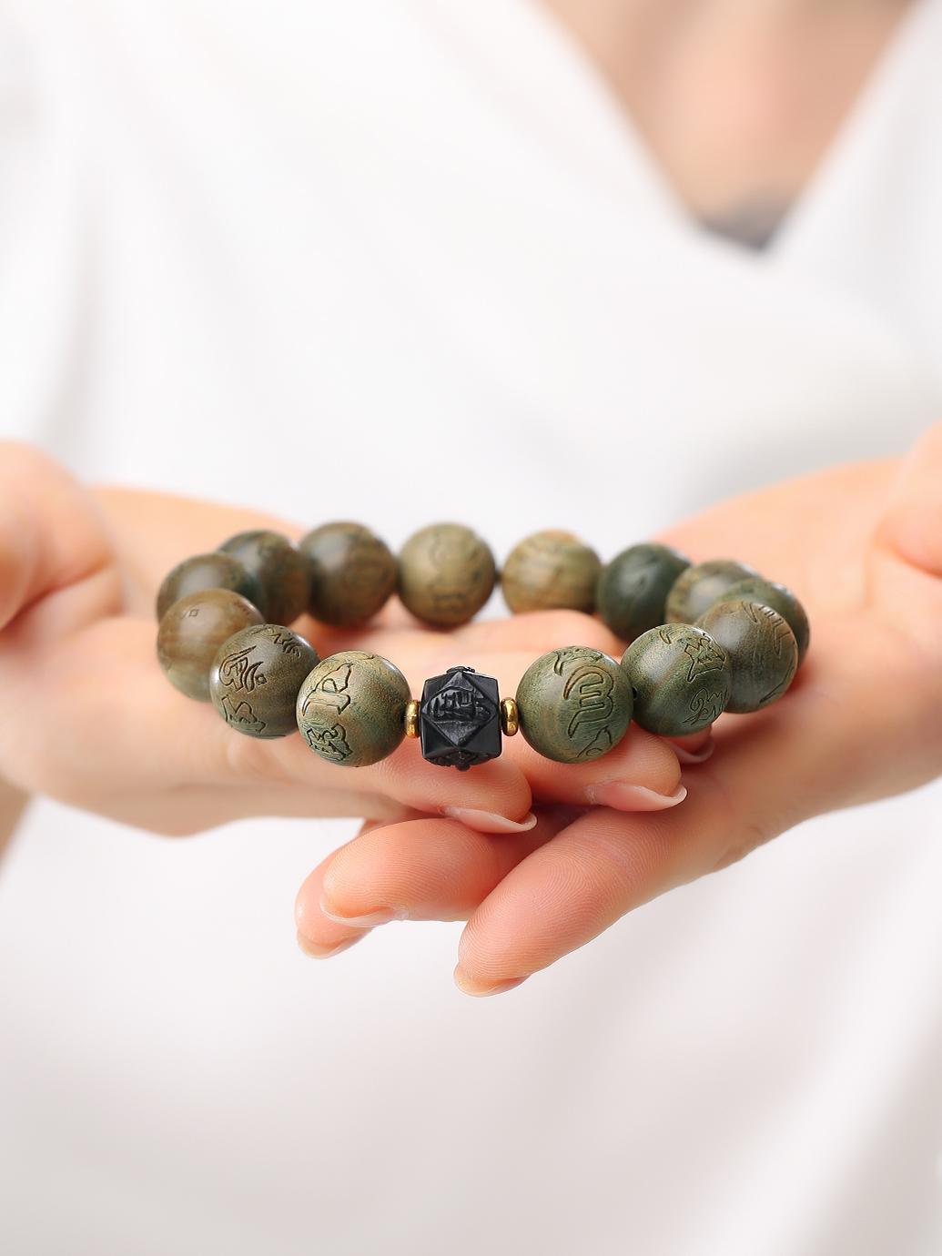 Spiritual sandalwood prayer beads handmade with natural green sandalwood and obsidian elements. This Tibetan Buddhist jewelry culture creation represents sacred craftsmanship for daily meditation and energy balancing.