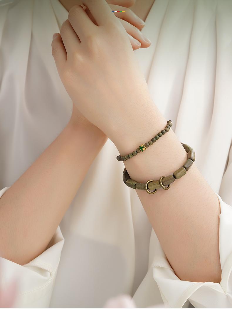 Breeze Meditation mala combining green sandalwood and sacred alloy components. This Tibetan Buddhist jewelry culture piece supports mindful practice through its handcrafted natural materials.