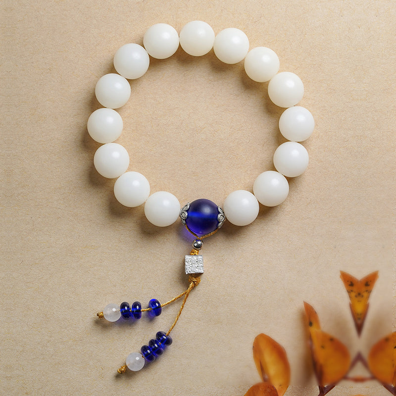 White Bodhi Root Mala handcrafted with lapis lazuli beads and Tibetan silver details. This Tibetan Buddhist jewelry culture piece embodies traditional Himalayan craftsmanship for meditation and spiritual awakening.