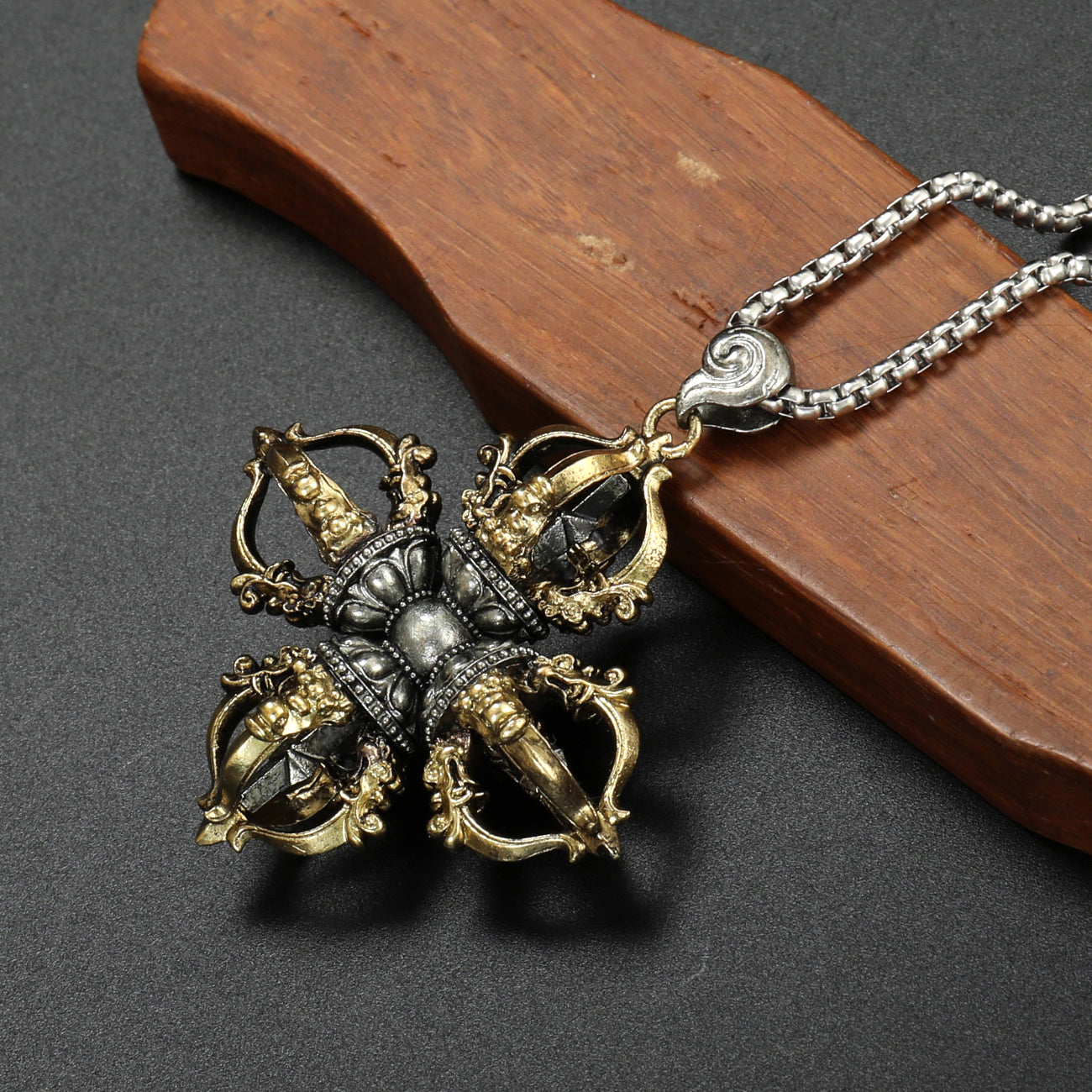 Handcrafted Tibetan Buddhist Capricorn Cross Vajra pendant in brass and white copper, with detailed craftsmanship representing spiritual strength.