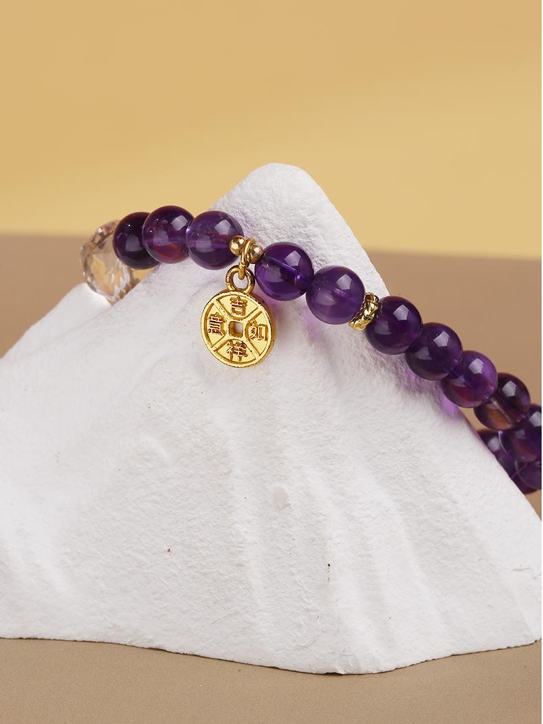 Amethyst and crystal bead bracelet designed with Tibetan Buddhist influences, bringing protection, healing, and clarity to the wearer’s life.