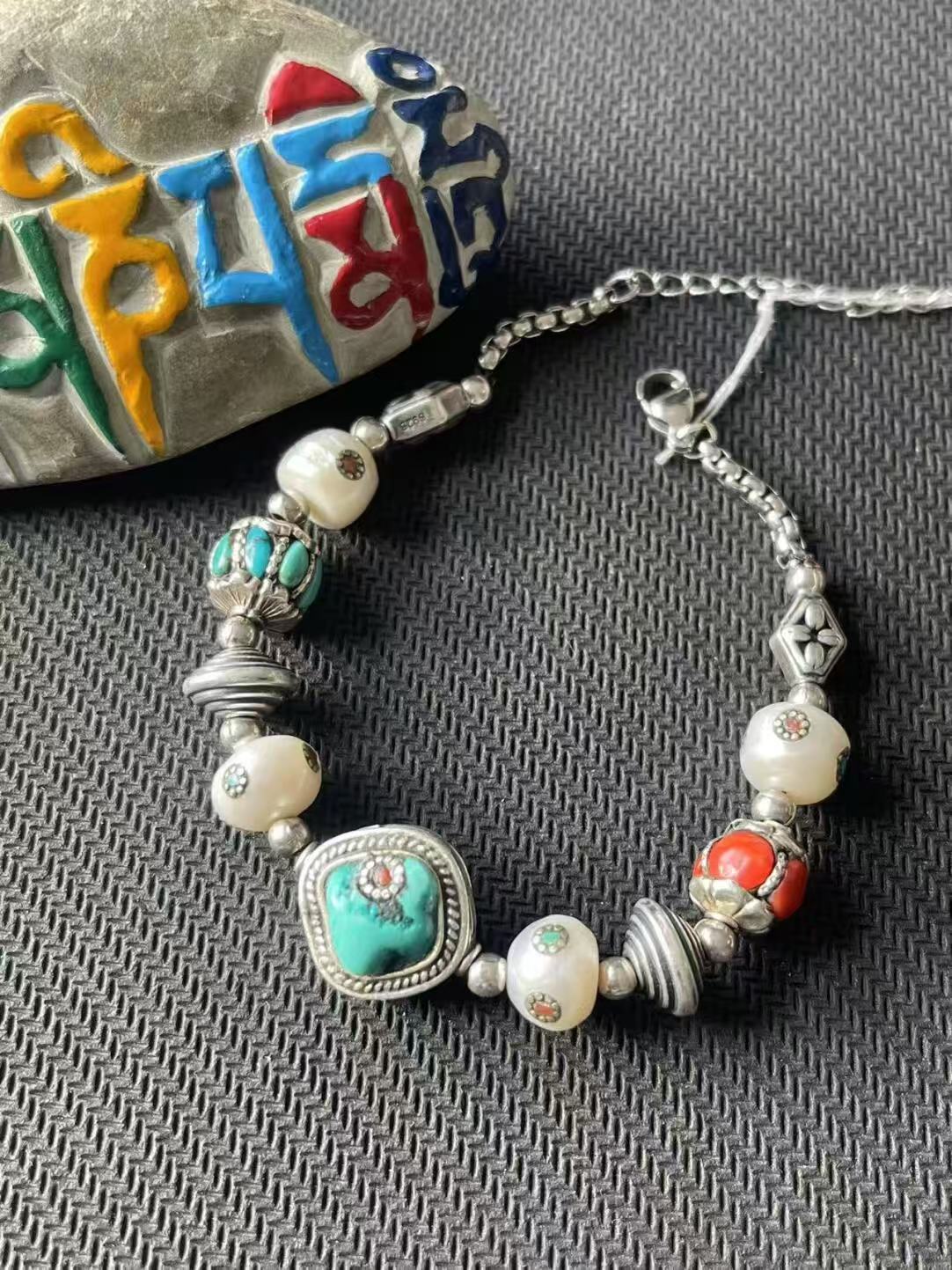 Handcrafted dazzling multi-treasure bracelet, embodying Tibetan Buddhist jewelry culture with vibrant colors and intricate design, perfect for spiritual fashion.