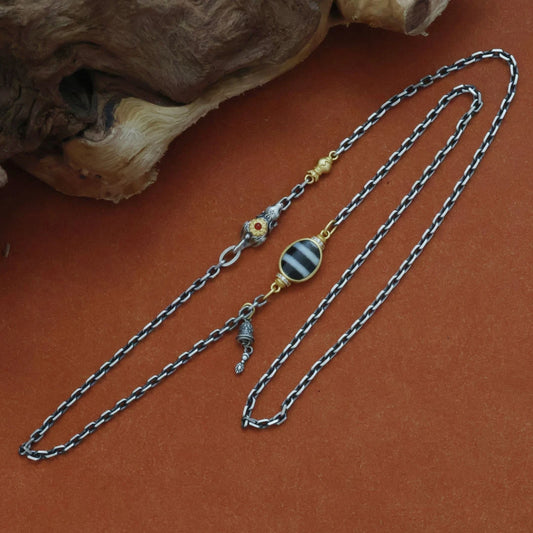 Handcrafted silver Treasure Mouse pendant necklace inspired by Tibetan Buddhist jewelry culture, symbolizing wealth attraction and abundance.