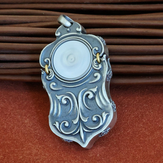 Handcrafted and carved Green Tara pendant with inlaid details and rotating feature inspired by Tibetan Buddhist Jewelry Culture