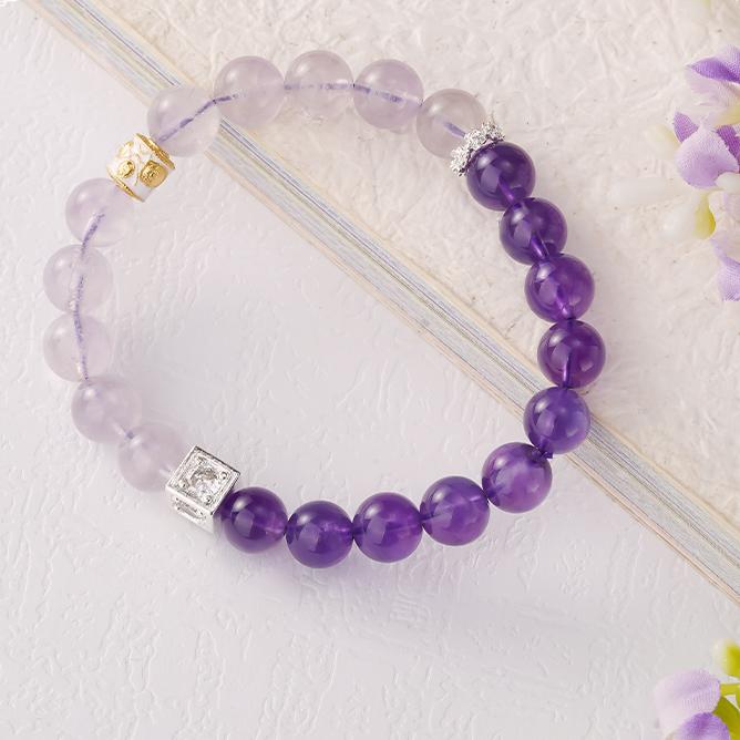 Handcrafted amethyst bracelet with a copper Caishen charm, symbolizing wealth and prosperity in Tibetan Buddhist culture. Perfect for attracting abundance.