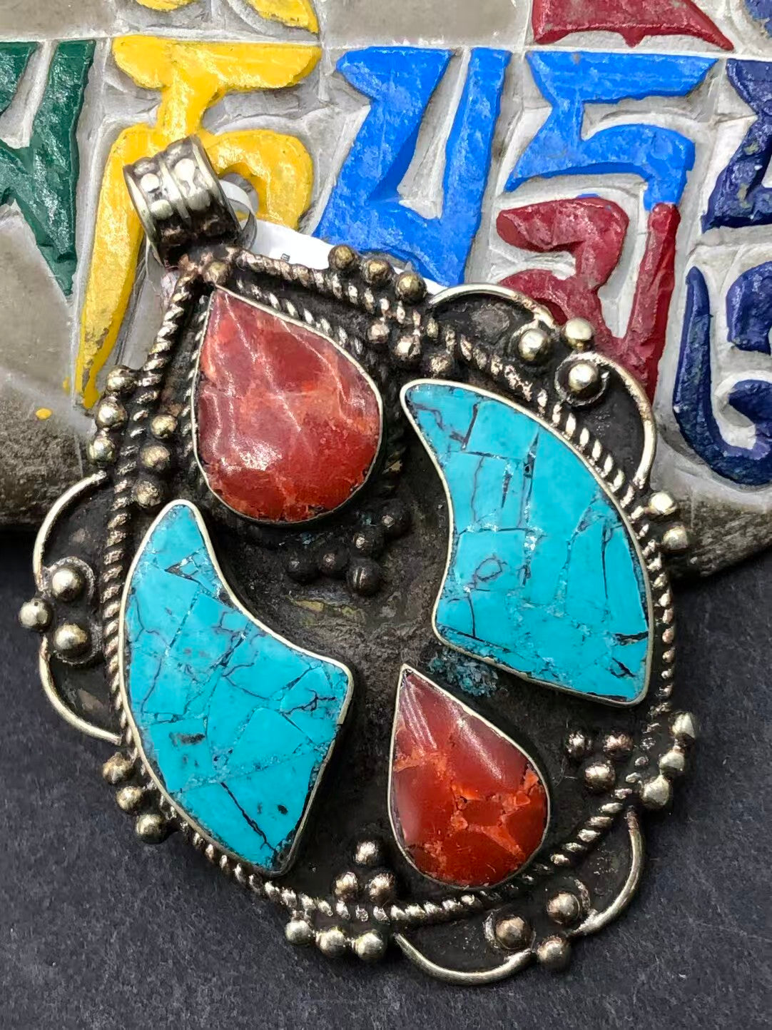 Handcrafted green turquoise pendant, designed with Tibetan Buddhist influences. This unique piece symbolizes peace, tranquility, and the journey toward enlightenment.
