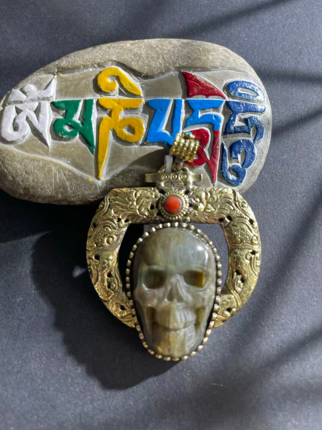 Handcrafted Labradorite pendant with a Tibetan Buddhist design. Features vibrant iridescent hues, symbolizing protection, healing, and spiritual clarity.