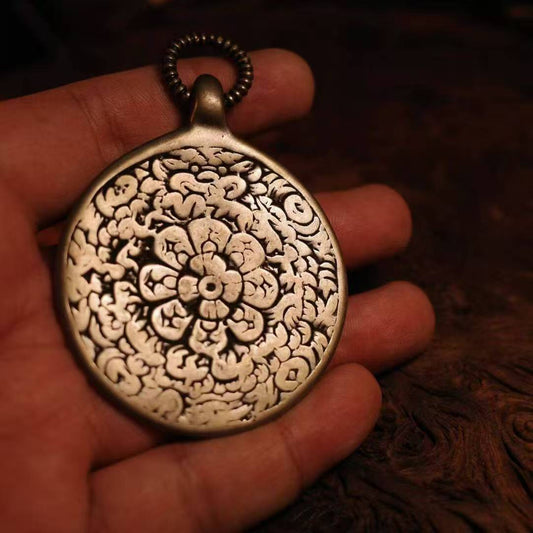 Ancient Tibetan Nine Palace Bagua amulet pendant, handmade jewelry art representing harmony and spiritual protection.
