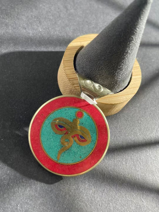 Hand-painted patch pendant inspired by Tibetan Buddhist art. This spiritual accessory combines cultural heritage with vibrant, meaningful design for inner peace.