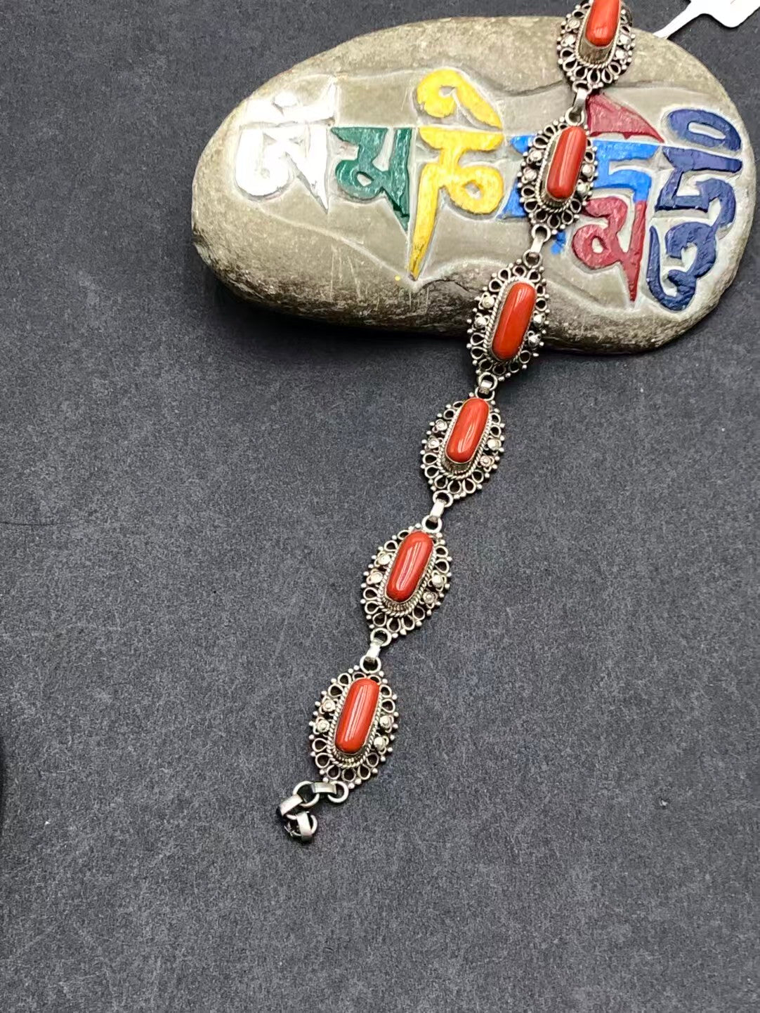 Exquisitely handcrafted red bracelet, combining Tibetan Buddhist jewelry culture with artistic design, symbolizing energy, vitality, and spiritual connection.
