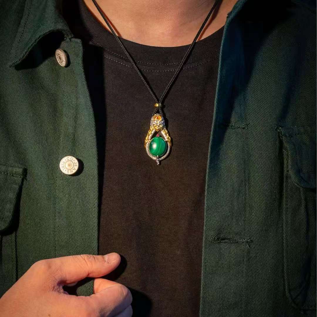 Handmade inlaid Garuda bird silver pendant from Tibetan Buddhist jewelry culture, a meaningful jewelry art talisman.