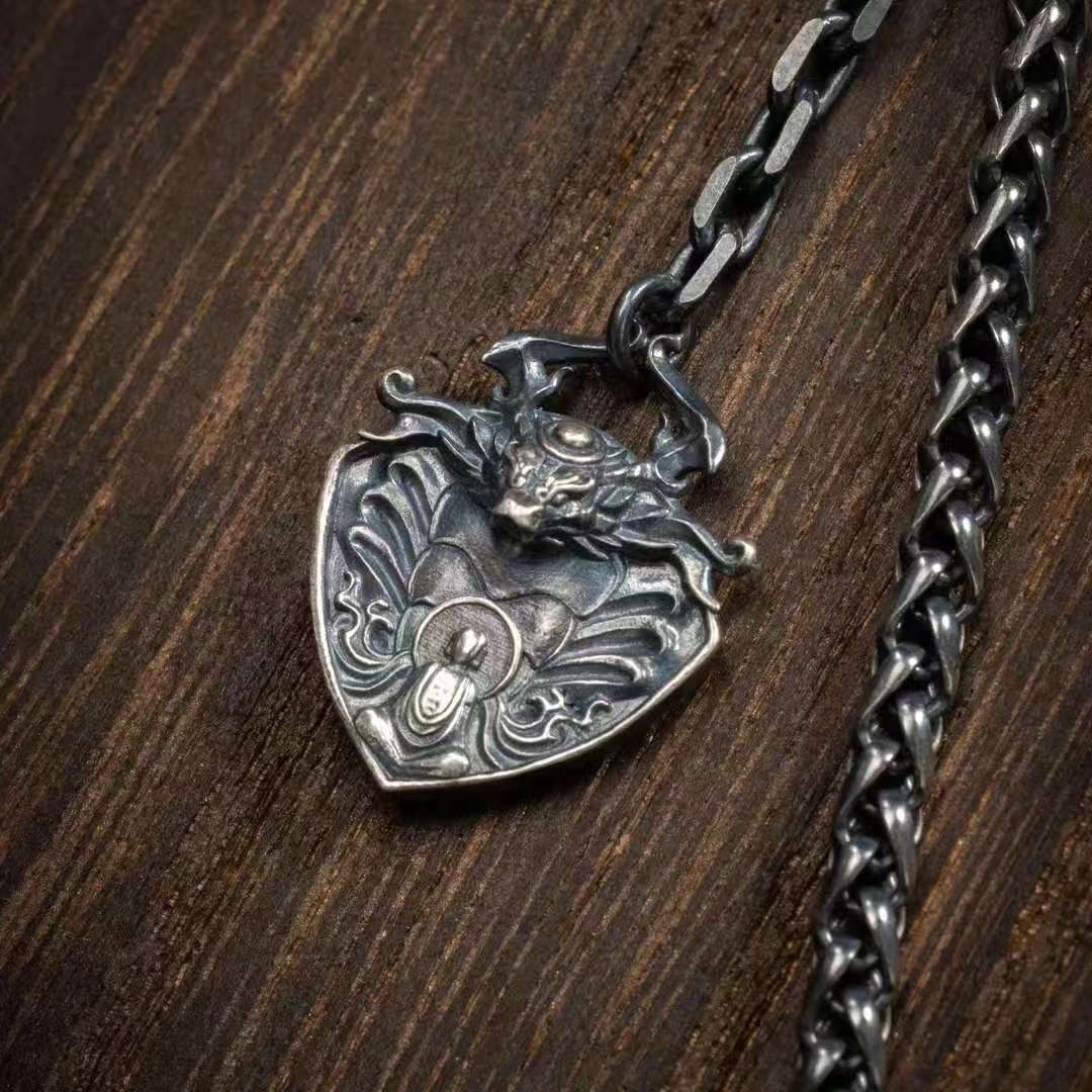 Sacred silver serpent pendant necklace rooted in Tibetan Buddhist jewelry culture, wearable spiritual protection.