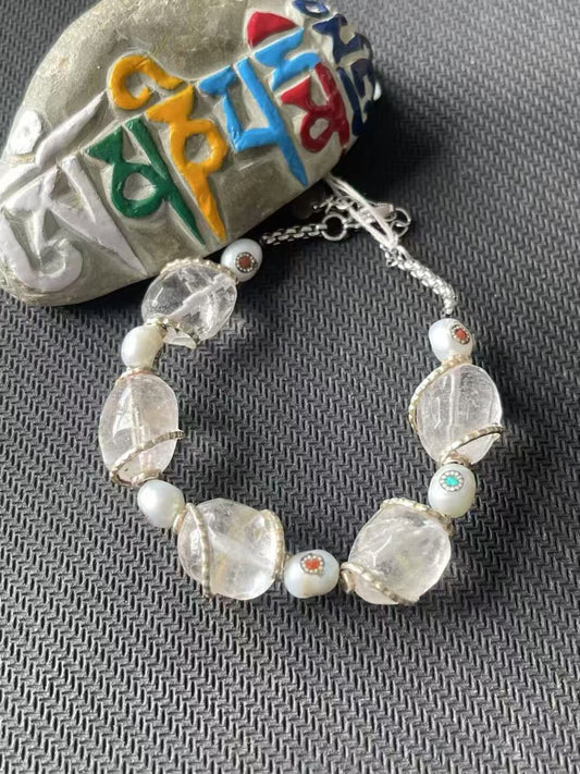 Alt Text: Purely handcrafted white crystal bracelet with intricate Tibetan Buddhist art. Designed to bring spiritual harmony and protection to the wearer.