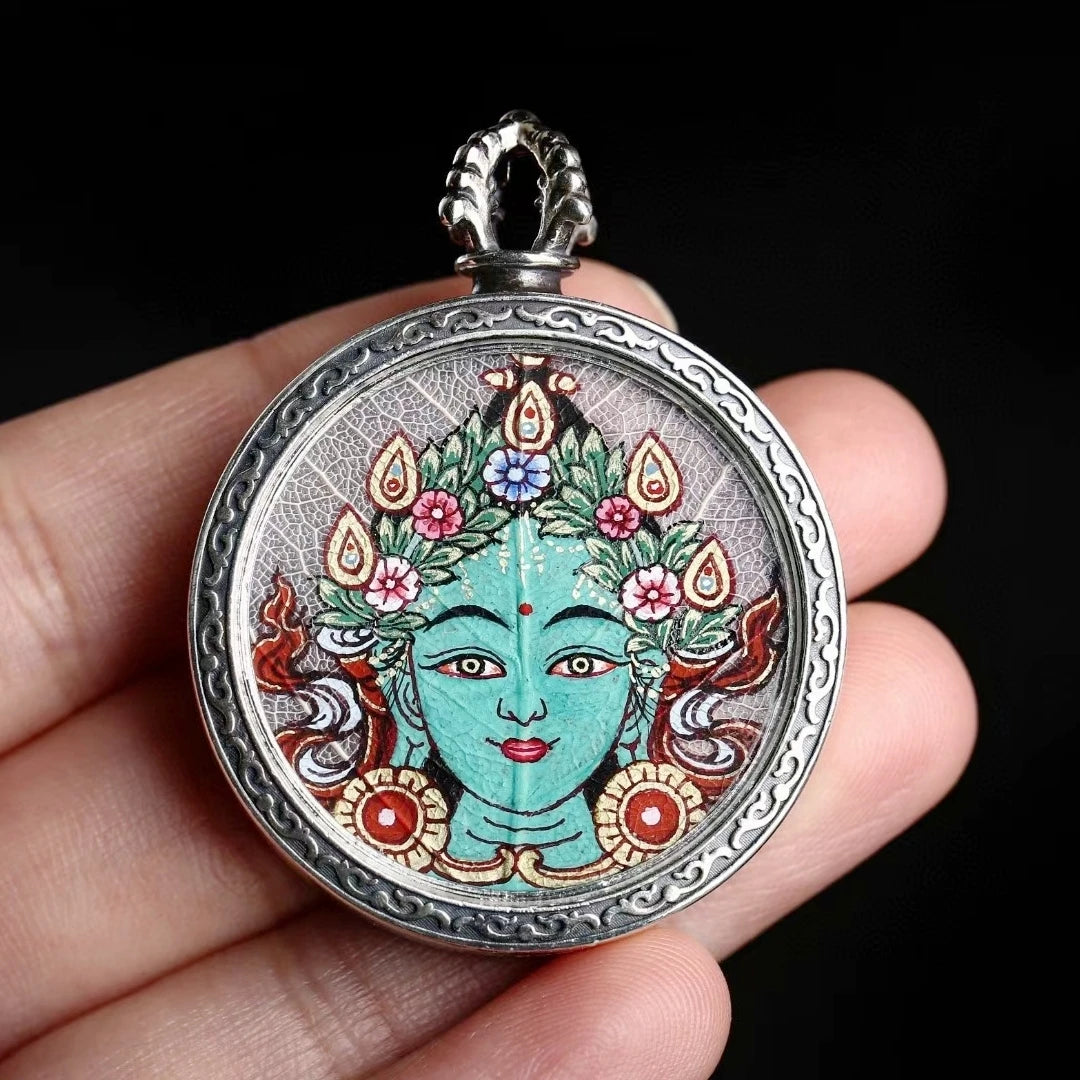 Sacred Zaki Lam Yellow Wealth Buddha Thangka pendant necklace with hand-painted Blue Bodhi Leaf design, offering blessings of abundance and protection