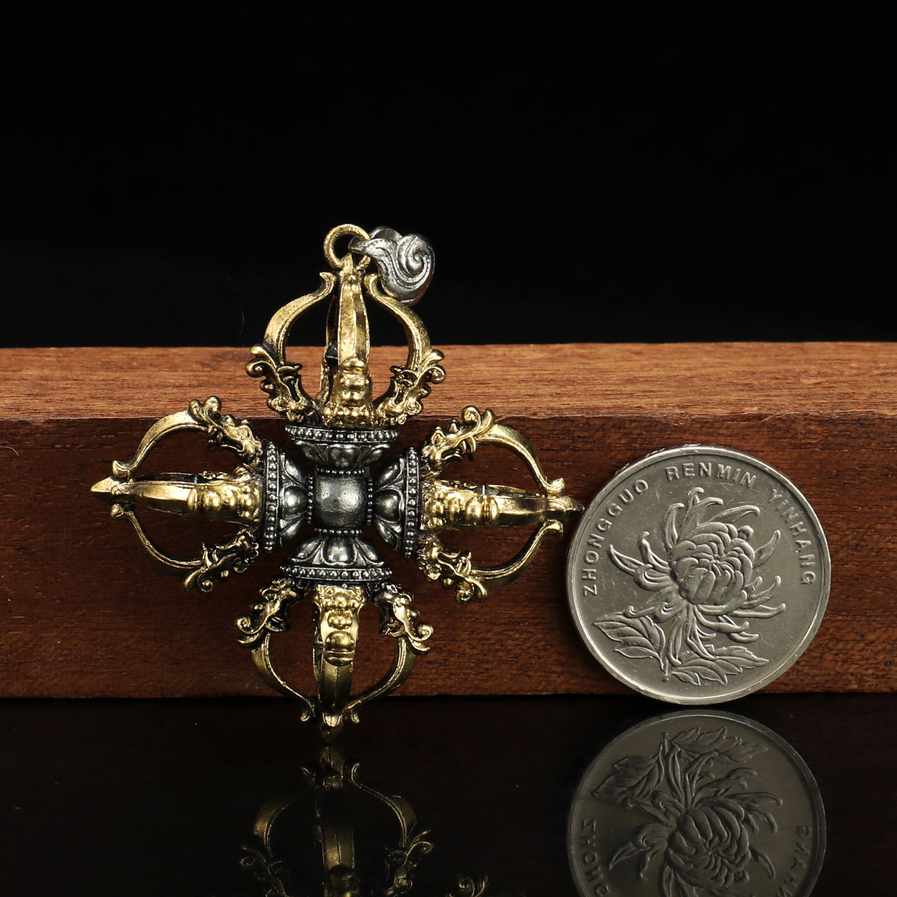 6cm Capricorn Cross Vajra pendant, hand-painted and crafted from brass and white copper, showcasing the intricate beauty of Tibetan Buddhist jewelry art.