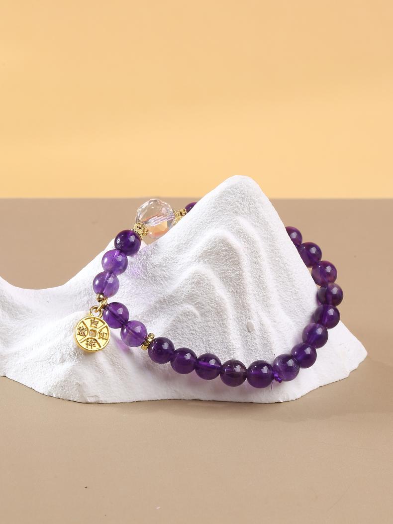 Amethyst and crystal bead bracelet, handcrafted with Tibetan Buddhist symbolism, offering protection, emotional healing, and spiritual energy for meditation.
